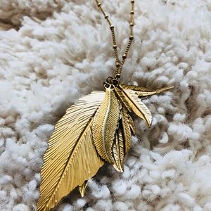Gold colored necklace w/multilayer pendant leaves